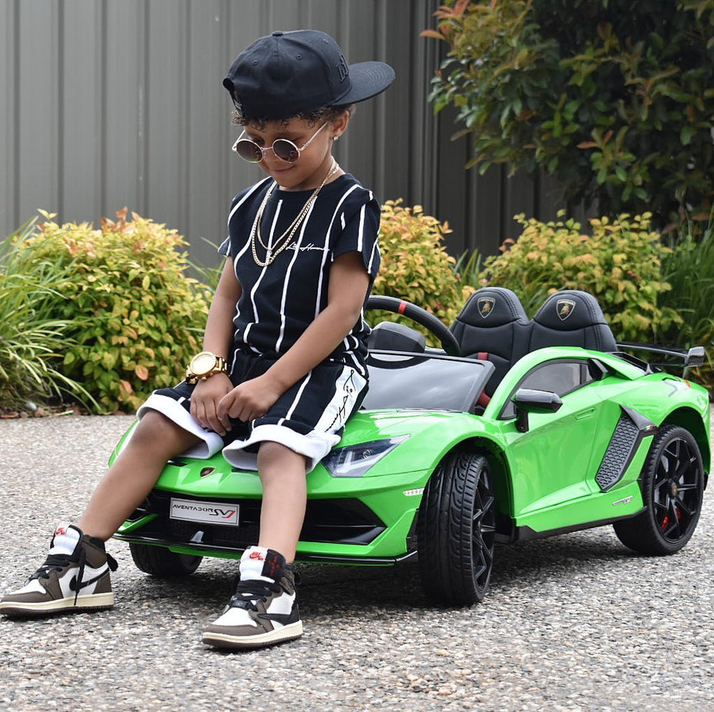 Boy sitting on a ride on car