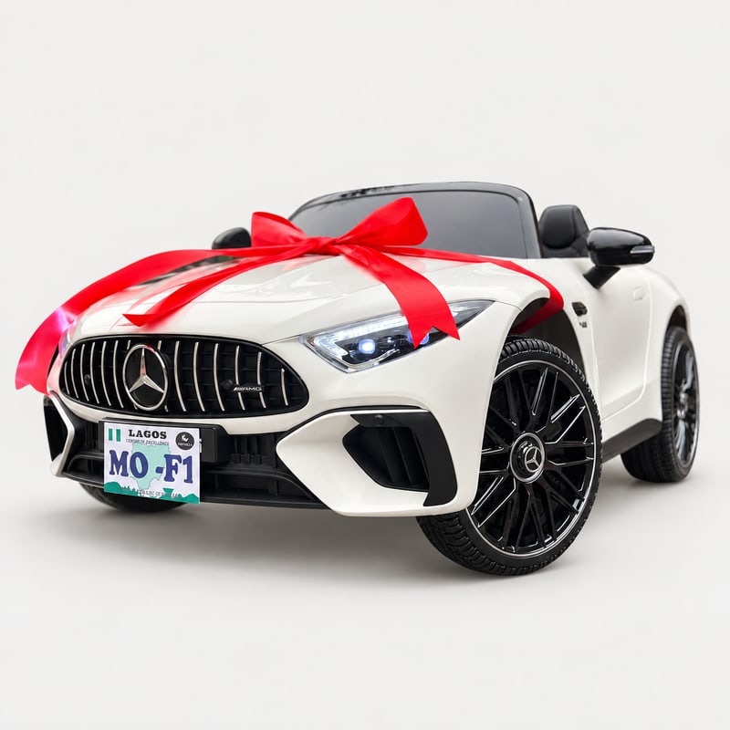 Mercedes SL63 — White electric ride-on, front three-quarter with gift bow, on a light-grey background.